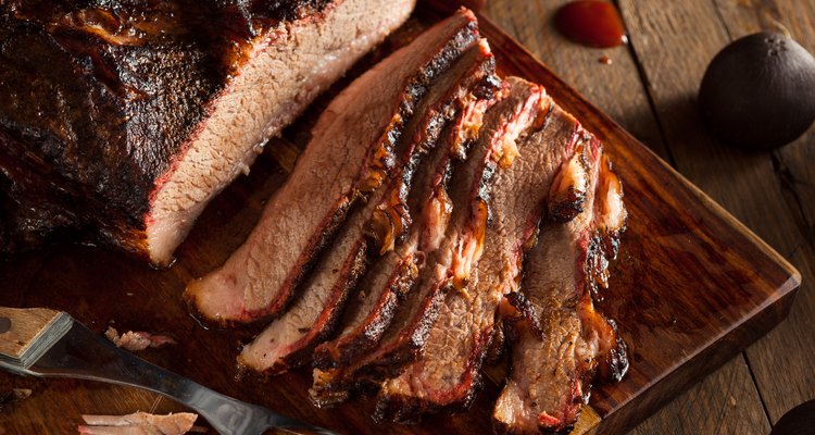 Sliced Crock-pot beef brisket on a wooden cutting board