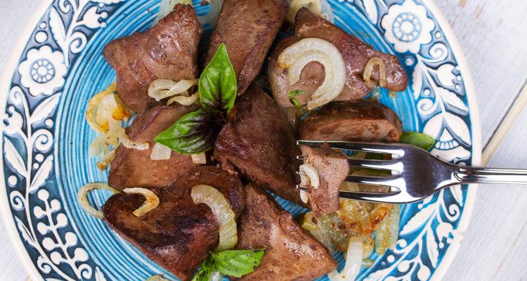 Sauteed liver with onions on blue plate