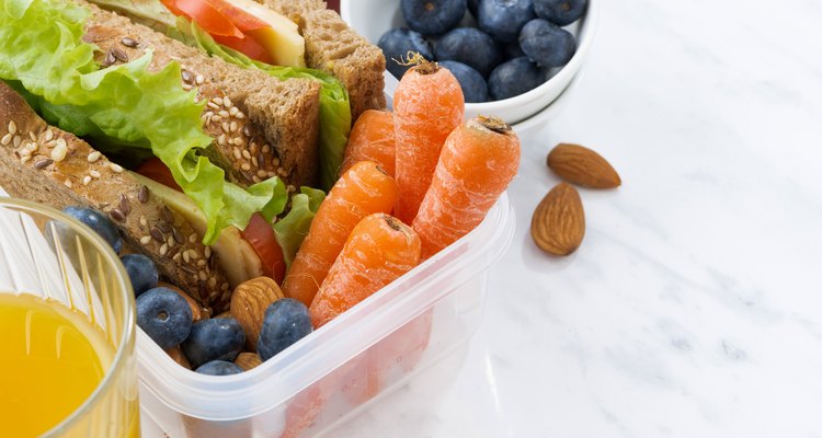 lunch box with sandwich of wholemeal bread on white background