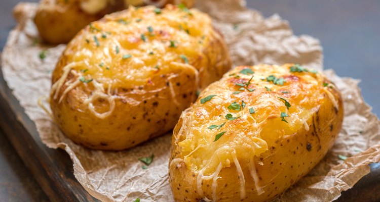 Baked loaded potato with bacon, cheese and onion