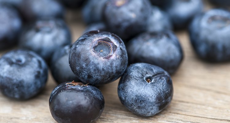 Close-up shot of blueberries on a wooden surface