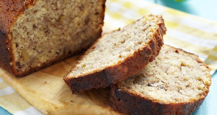 Homemade banana bread sliced on a wooden cutting board