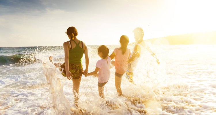 Women friends at the beach with young kids