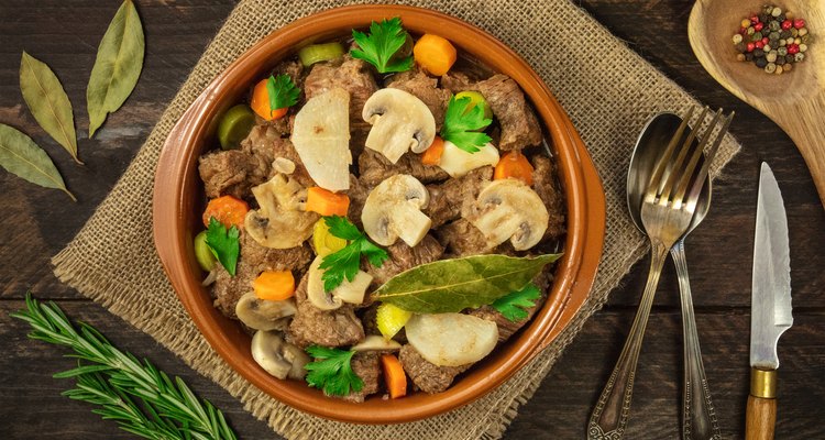 Overhead photo of meat and mushrooms ragout with herbs