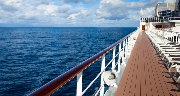 Empty sun loungers on deck of ship