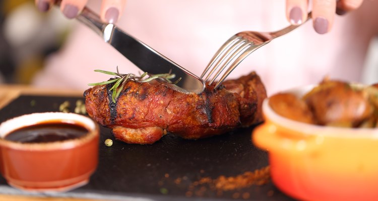 woman eating steak in a restaurant