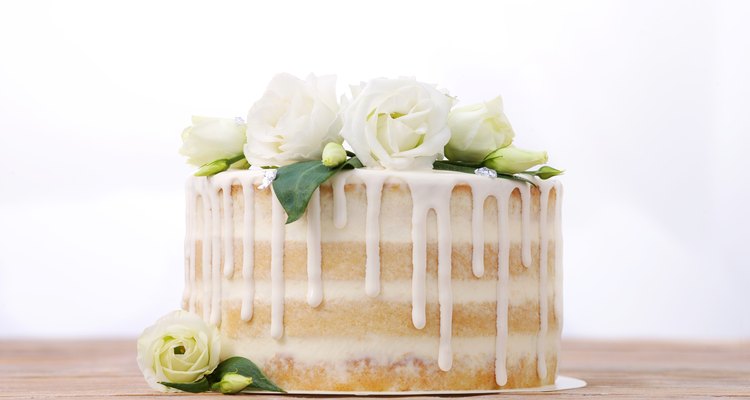 White layer cake with icing, decorated with flowers