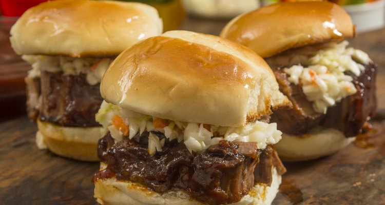 beef brisket sliders smothered in  sauce and topped with slaw