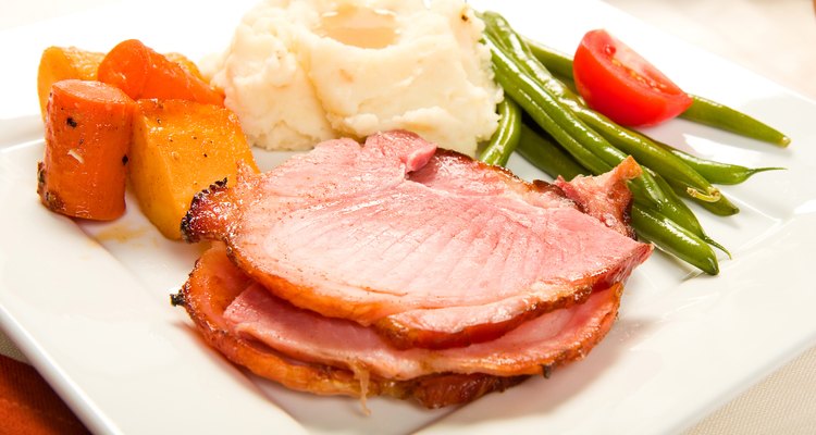 A roast ham dinner with vegetables