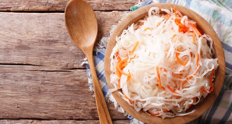 sauerkraut in a wooden plate horizontal top view, rustic