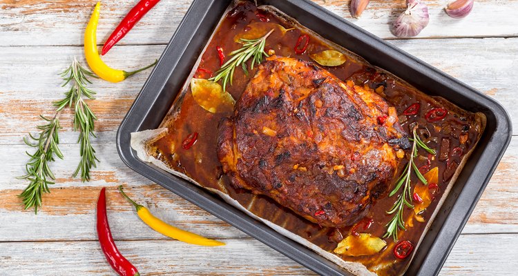 Whole roast shoulder of pulled pork in roasting pan