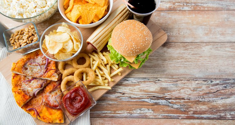 close up of fast food snacks and drink on table