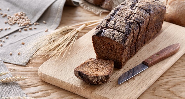 Sliced black bread on a wooden table