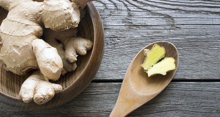 Overhead shot of ginger on dark wooden background