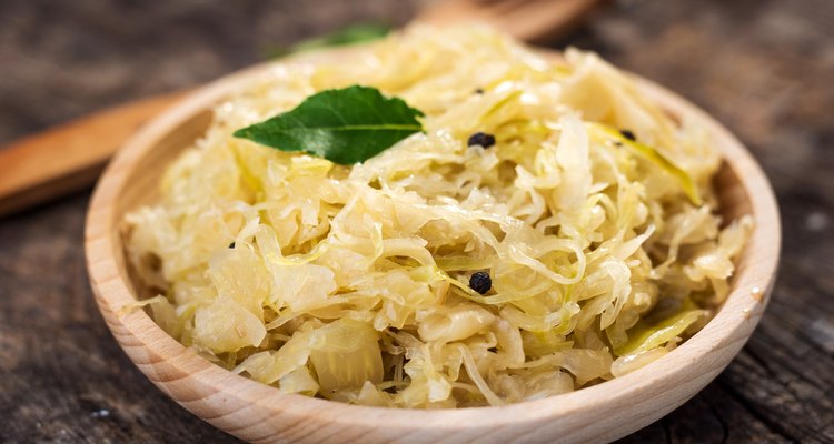 Steamed sauerkraut on old wooden background