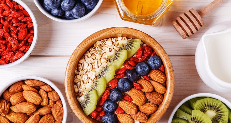 Bowl of oat flakes with fresh fruit, almond and honey.