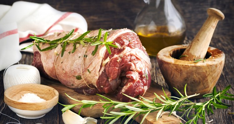 Raw boneless lamb leg with garlic and rosemary