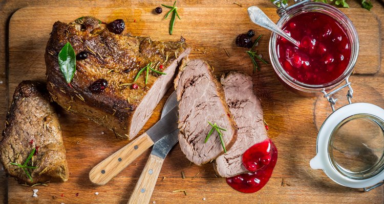 Freshly served venison with cranberries and rosemary