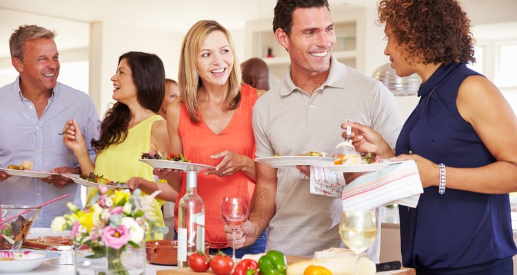 Group Of Mature Friends Enjoying Buffet At Dinner Party