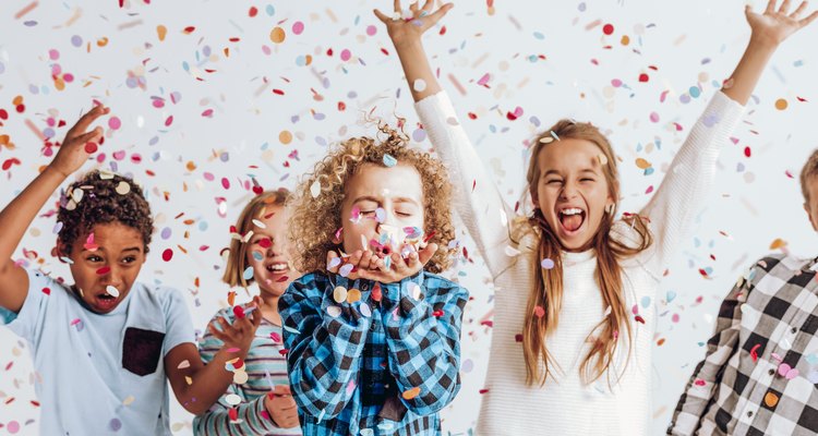 Kids in a room full of confetti