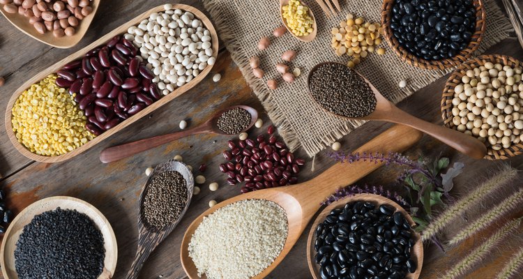 Top view of various legumes with cookware