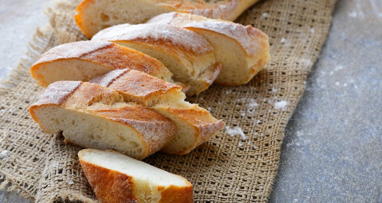 Sliced homemade French bread on sackcloth