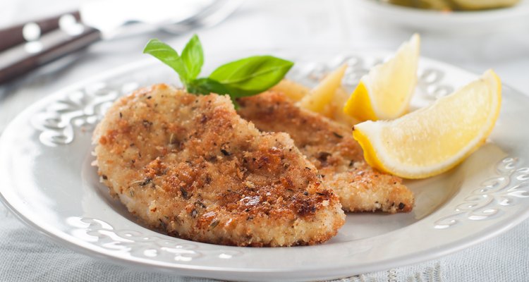 Parmesan crusted chicken with lemon slices on a plate