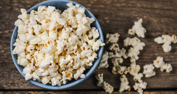 Popcorn in a bowl on wooden table