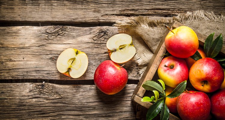 Fresh red apples in wooden box.