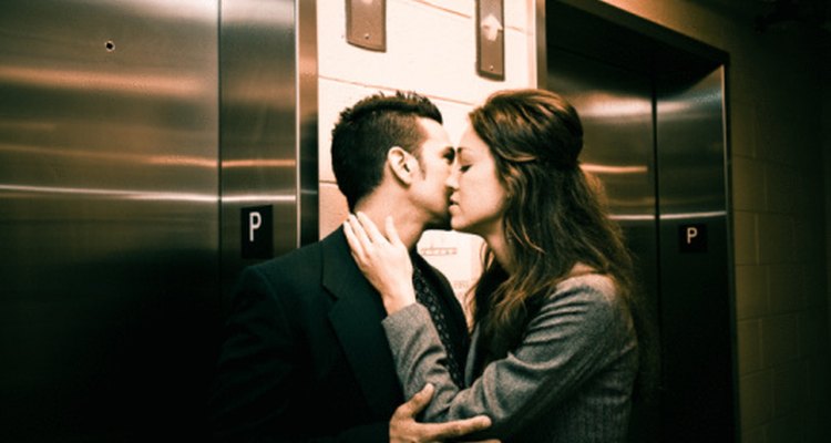 Couple kissing by an elevator