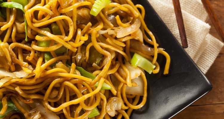 Homemade Asian chow mein noodles on a plate with chopsticks
