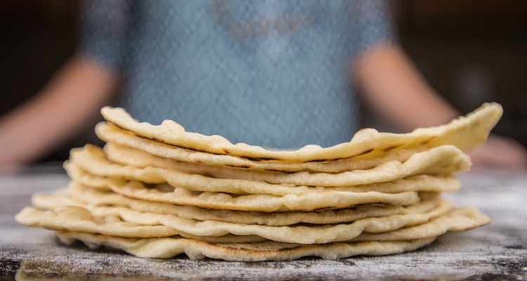 Stack of Homemade Tortillas on floured surface