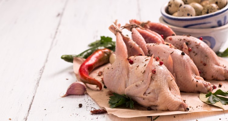 Fresh organic quails on vintage wooden table, healthy food