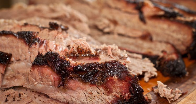 A wooden tray of sliced brisket