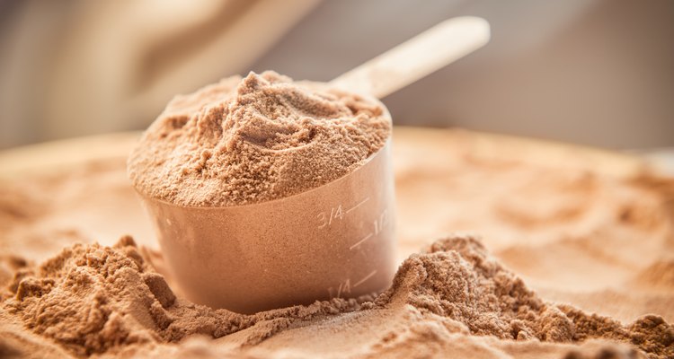 Chocolate whey protein powder with a filled scoop