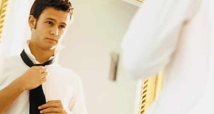 Man putting on tie