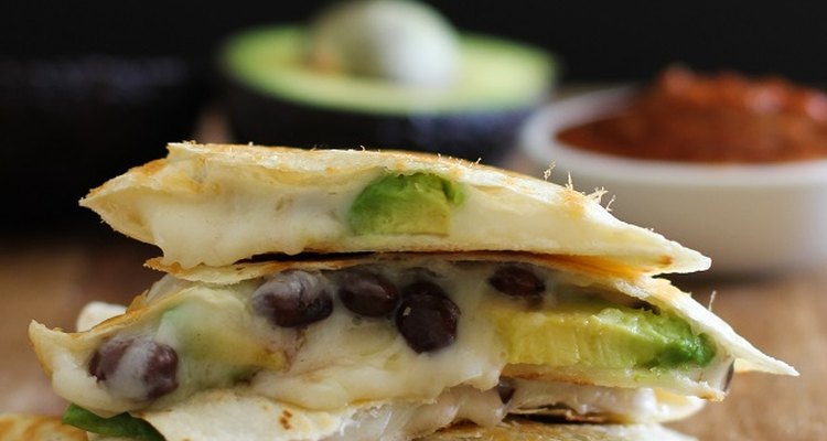 Stacked wedges of a black bean and avocado quesadilla.