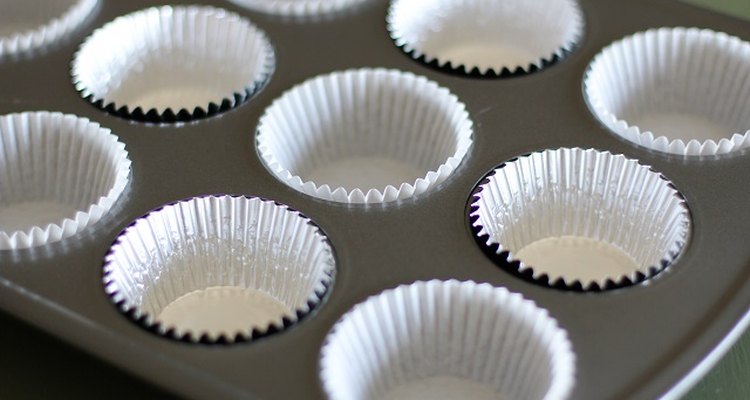 Muffin tray lined with foil baking cups.