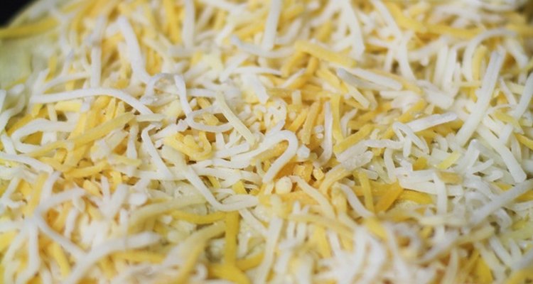 Tortilla and grated cheese in a skillet.