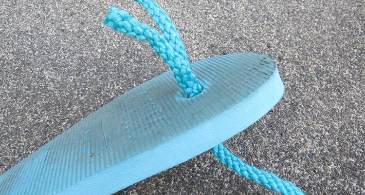 String rope through the top hole of the sole.