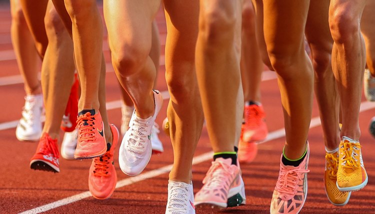 Women Running On Athletic Track by Jupiterimages