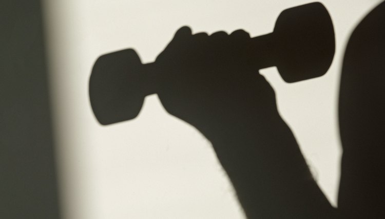 Sunlit shadow of a dumbbell being lifted in a bicep curl weight training exercise. Monochrome minimalism