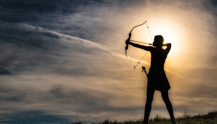 Girl with arc. Archery is inexpensive, enjoyable recreation