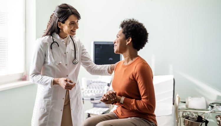 Female medical practitioner reassuring a patient