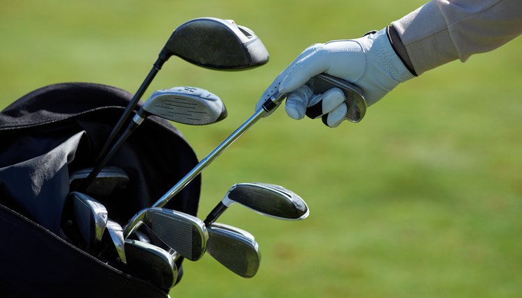 Closeup of golf player choosing club