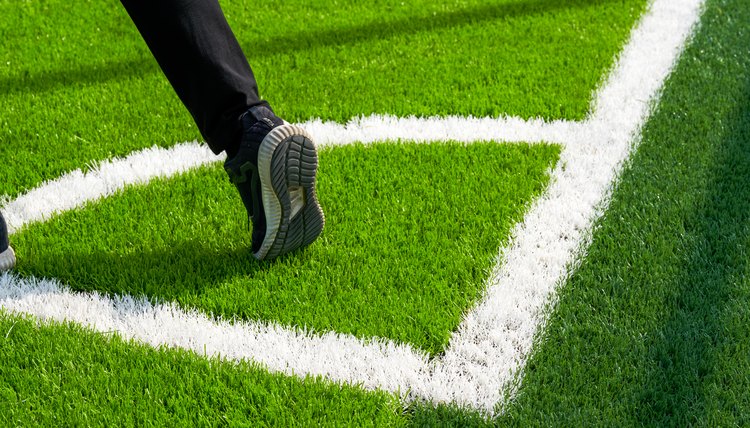 A player takes a corner kick on a brand new soccer field