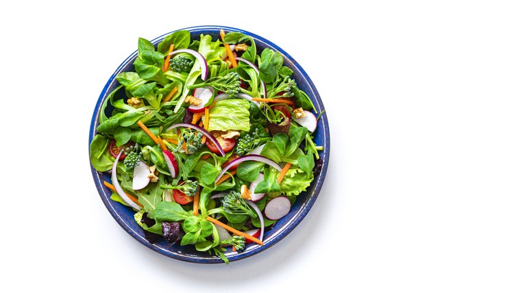 Healthy fresh green salad plate shot from above on white background