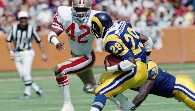 Rams Eric Dickerson runs against 49'ers Ronnie Lott during Los Angeles Rams v. San Francisco 49'ers game