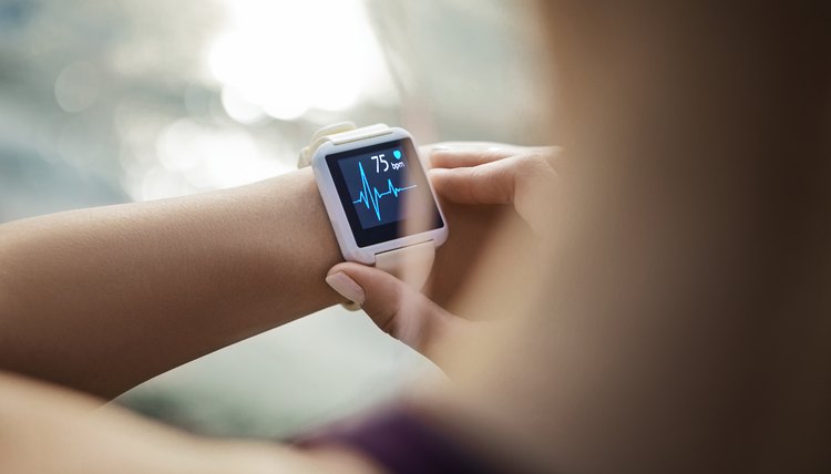 Woman Looking At Her Smart Watch for a pulse trace