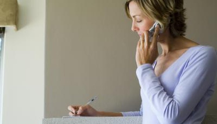 Womam on phone and writing